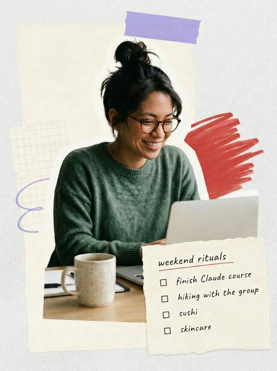 A woman smiling while working on her laptop